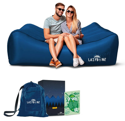 Chillbo Lazybone Inflatable Couch in royal blue with couple sitting on it, ideal inflatable lounger for camping or music festivals.